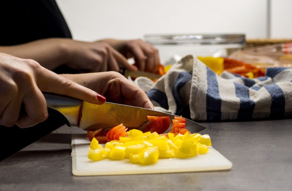 Hands chopping vegetables