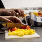Hands chopping vegetables